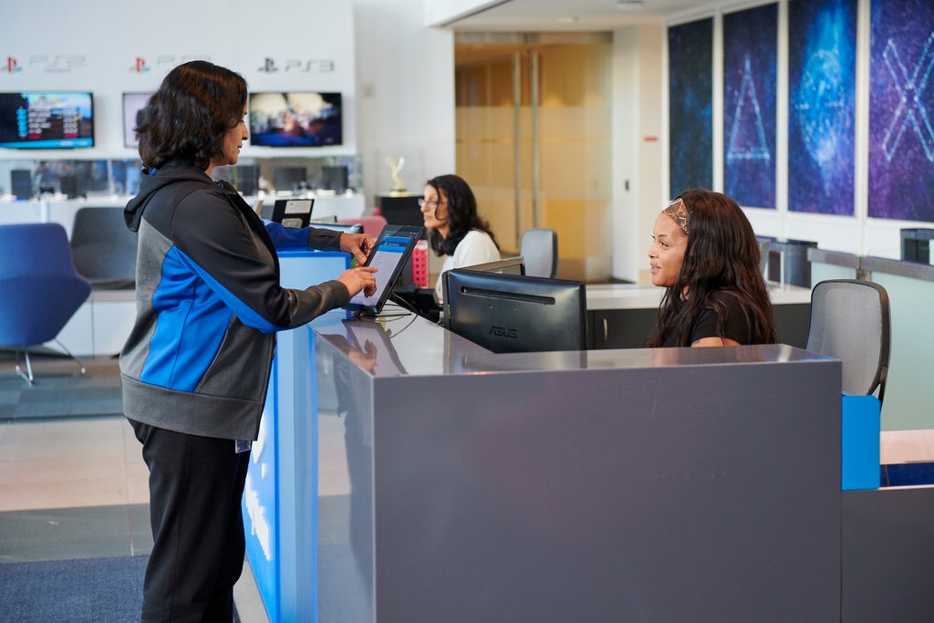 Media inquiries section of the site,  with an image of the front desk staff checking in a presumed media rep using an iPad check-in process.
