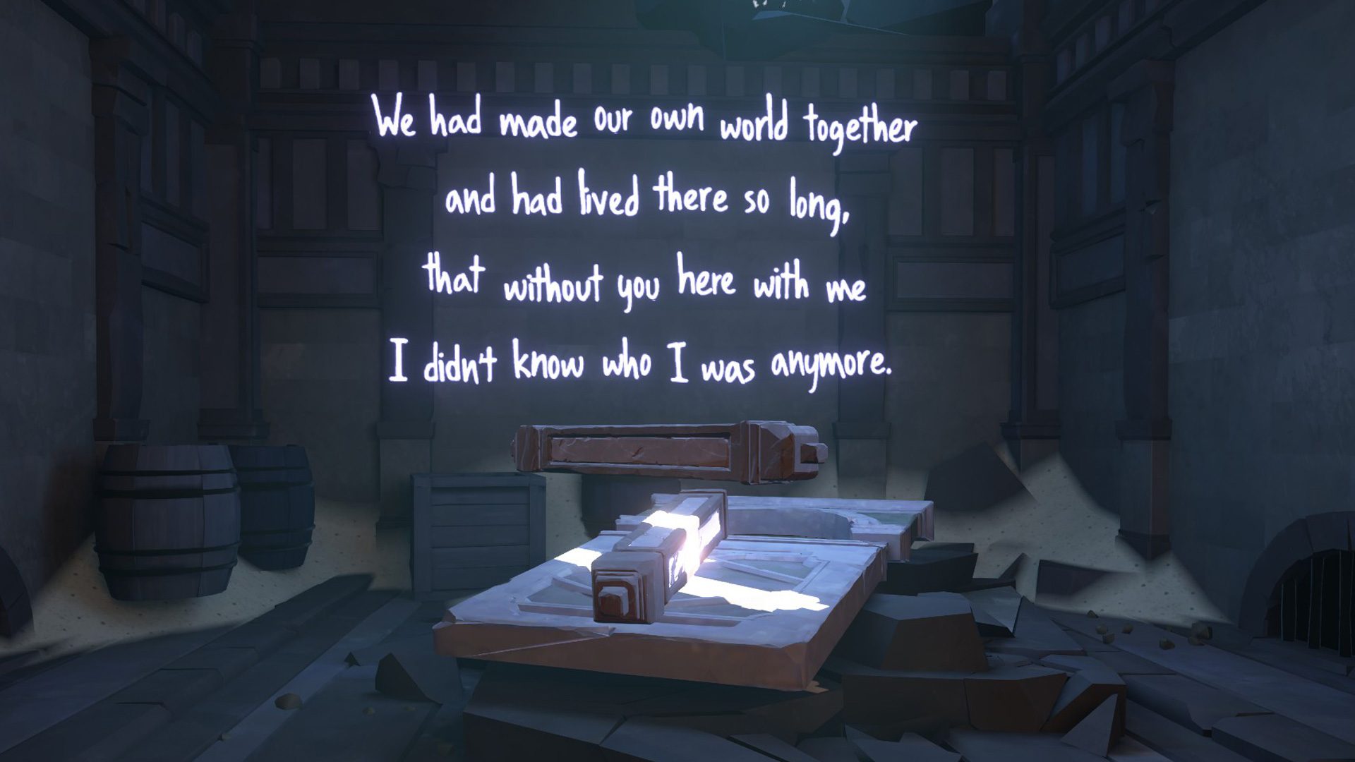 A dark room is pictured with a beam of light shining diagonally across a flat table. Illuminated white neon text is show against a wall. It reads "We had made our own world together and had lived there so long, that without you here with me I didn't know who i was anymore."