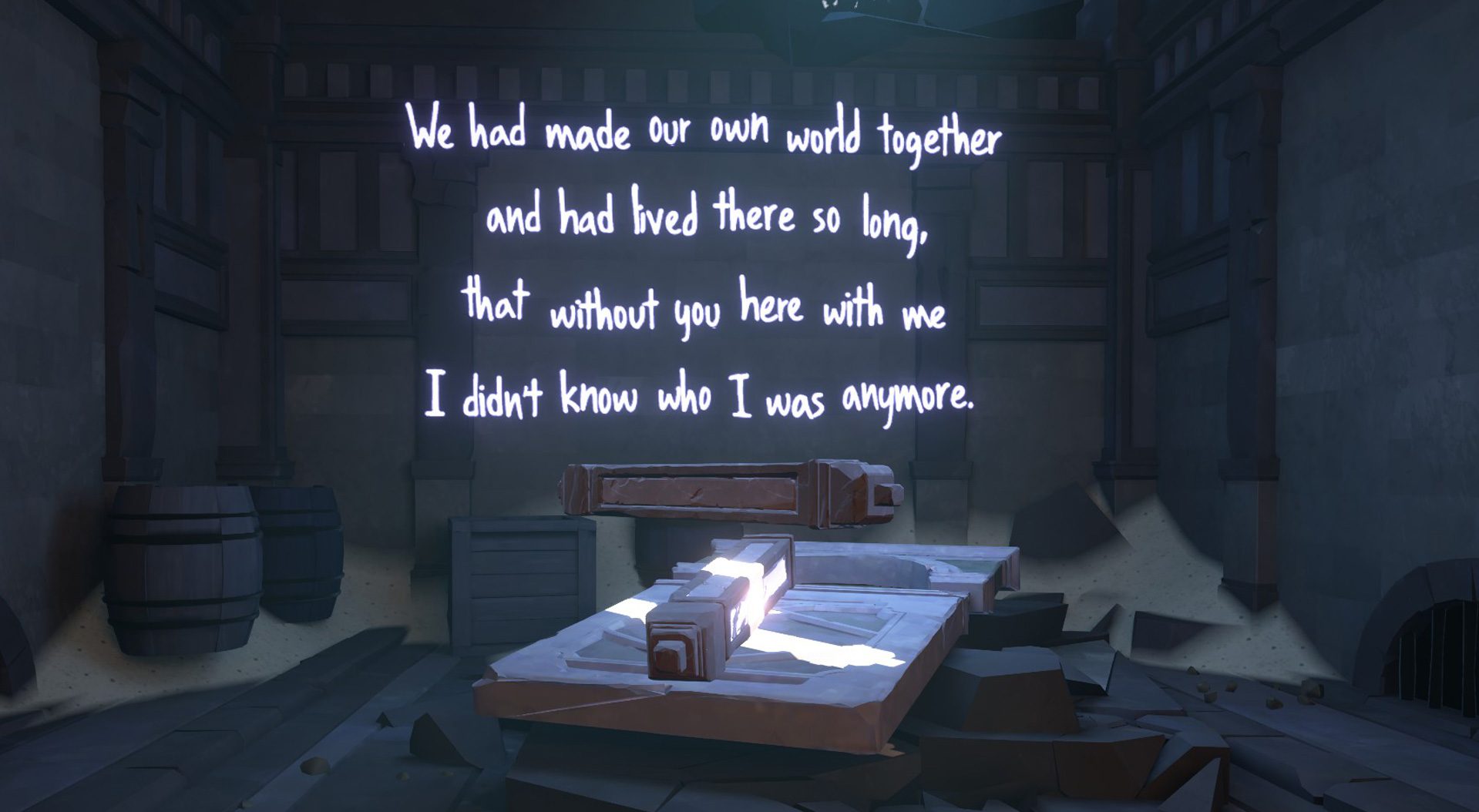 A dark room is pictured with a beam of light shining diagonally across a flat table. Illuminated white neon text is show against a wall. It reads "We had made our own world together and had lived there so long, that without you here with me I didn't know who i was anymore."