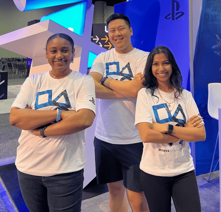 Interns posing together, two girls and one boy, with intern logo tees on and their arms are crossed like they are ready to face the world!