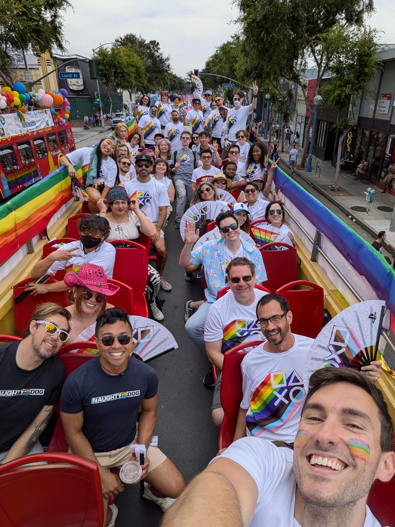 A group photo of Los Angeles-based PlayStation Studios members on top of the double decker bus.