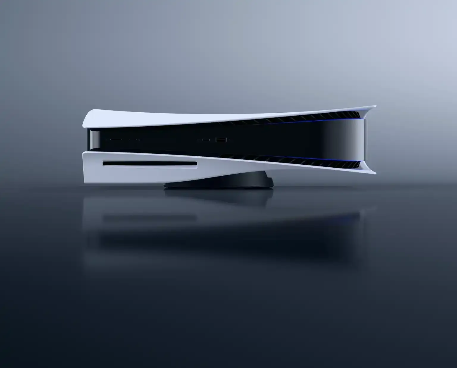 A horizontal PlayStation 5 on a glossy surface with a gray background. 