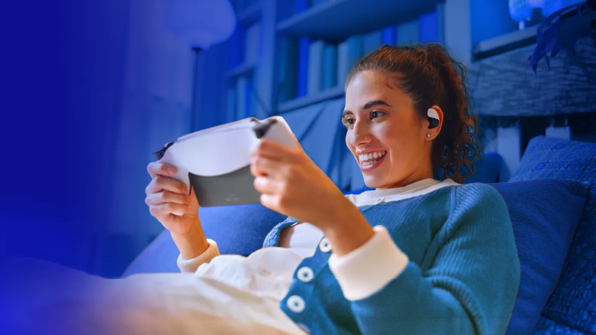 Gamer smiling while playing on PlayStation portal