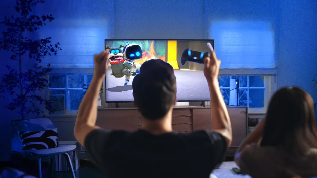 Gamer playing Astro Bot on a TV.