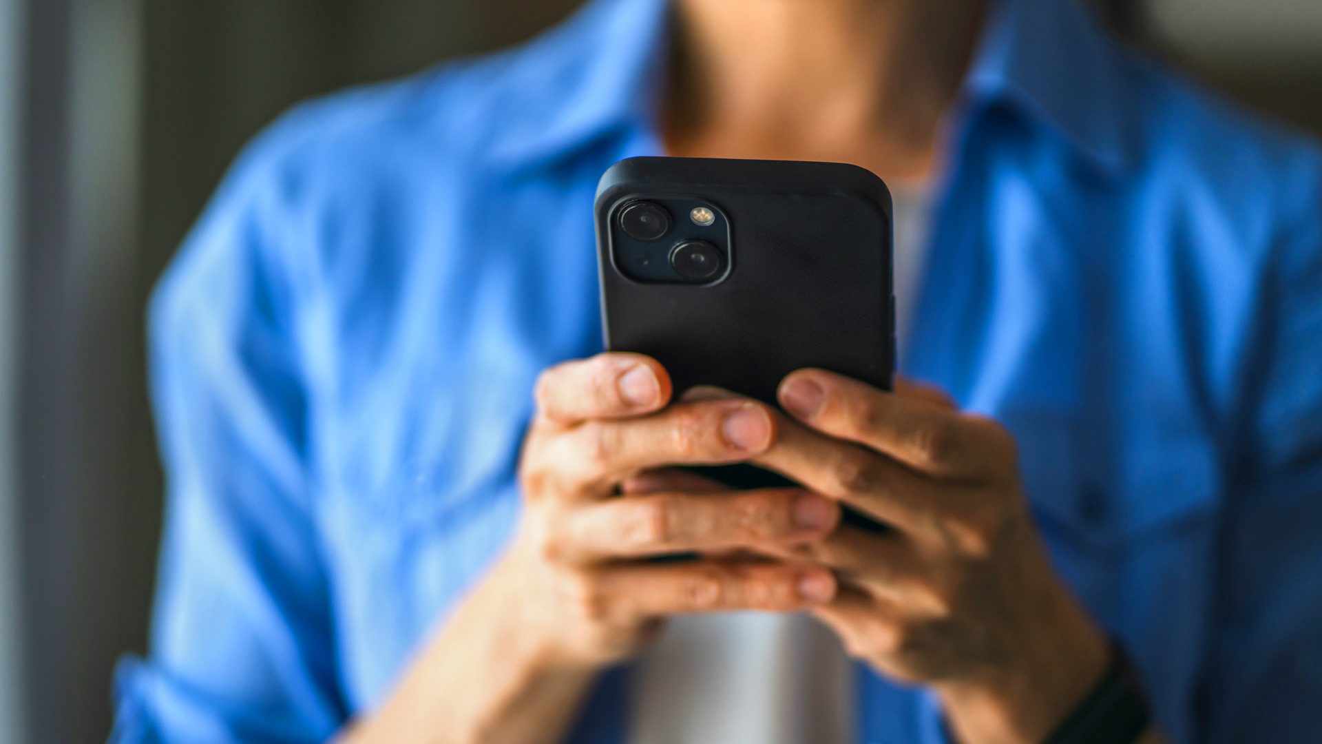 Hands holding mobile phone